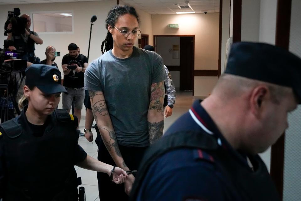 WNBA star and two-time Olympic gold medalist Brittney Griner, center, is escorted into a courtroom before a hearing, in Khimki, just outside Moscow, Russia, August 4, 2022.