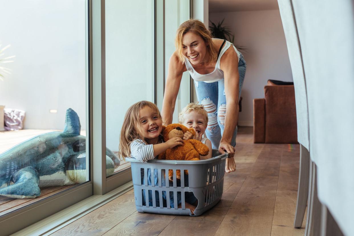 mother playing with her children at home