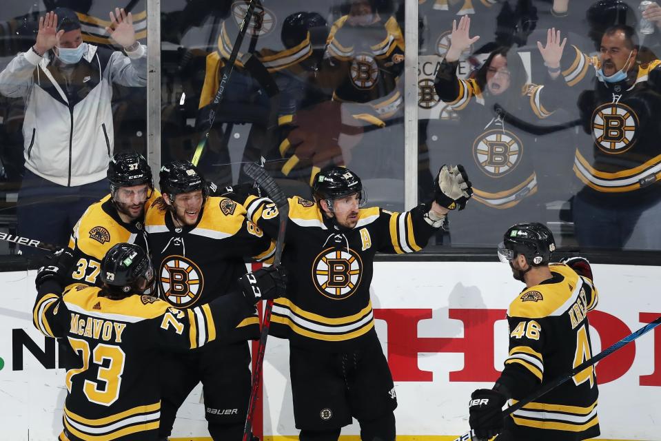 Boston Bruins' Brad Marchand (63) celebrates his goal with Charlie McAvoy (73), Patrice Bergeron (37), David Pastrnak (88) and David Krejci (46) during the second period in Game 4 of an NHL hockey Stanley Cup first-round playoff series against the Washington Capitals, Friday, May 21, 2021, in Boston. (AP Photo/Michael Dwyer)