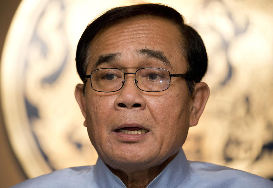 Thailand's Prime Minister Prayuth Chan-ocha leaves after a press conference at the government house in Bangkok, Thailand, Tuesday, March 26, 2019. An international election observation group criticized the vote-counting in Thailand's first election since a 2014 military coup, saying in its report Tuesday the "tabulation and consolidation of ballots were deeply flawed." (AP Photo/Sakchai Lalit)