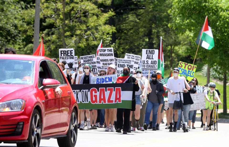 Protesters march up Newton Road on their way to Carver-Hawkeye Arena calling for the University of Iowa to divest from Israel Sunday, May 12, 2024 in Iowa City, Iowa.