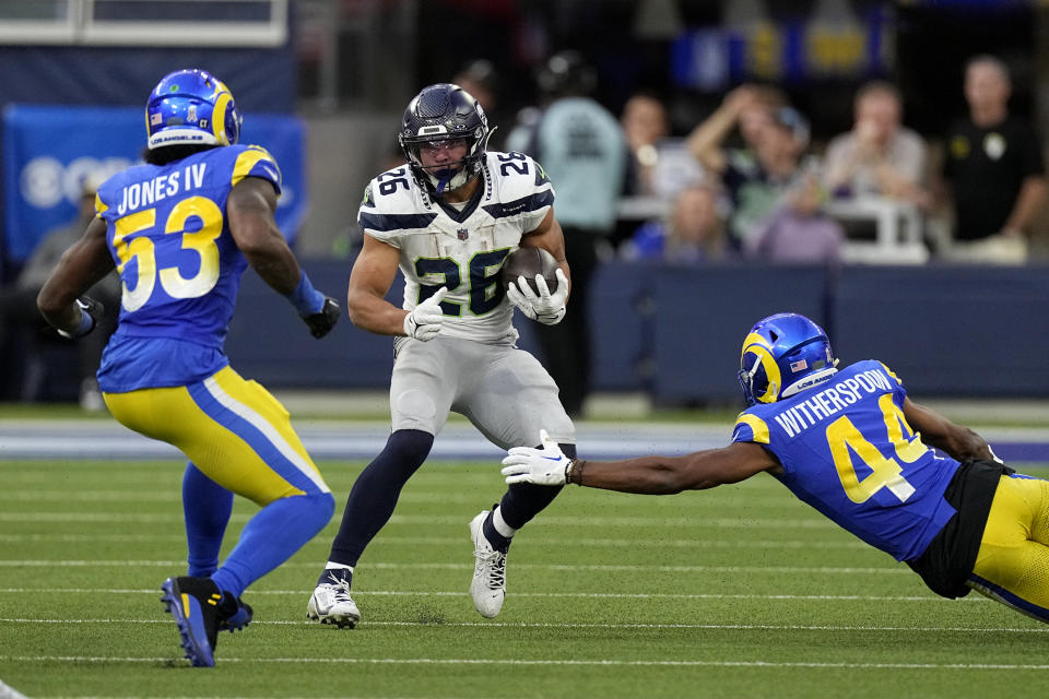 Seattle Seahawks running back Zach Charbonnet (26) runs the ball as Los Angeles Rams linebacker Ernest Jones (53) and cornerback Ahkello Witherspoon (44) chase during the second half of an NFL football Sunday, Nov. 19, 2023, in Inglewood, Calif. (AP Photo/Mark J. Terrill)