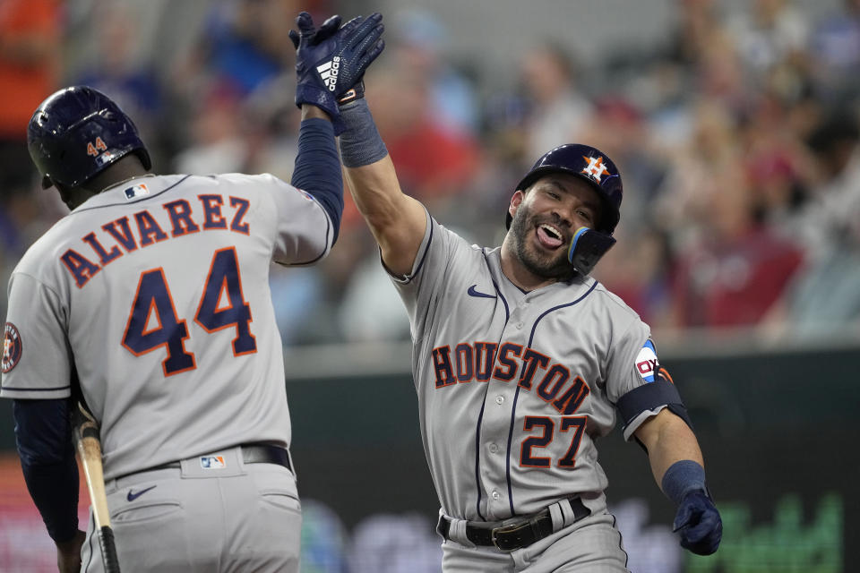 Houston Astros' Yordan Alvarez (44) and Jose Altuve (27) celebrate after Altuve's solo home run in the sixth inning of a baseball game against the Texas Rangers, Monday, Sept. 4, 2023, in Arlington, Texas. (AP Photo/Tony Gutierrez)