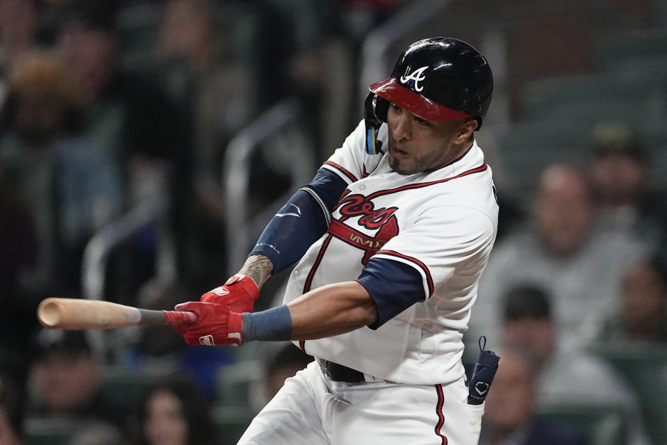 Atlanta Braves left fielder Eddie Rosario drives in a run with a triple during the eighth inning of the team's baseball game against the Miami Marlins Wednesday, April 26, 2023, in Atlanta. (AP Photo/John Bazemore)