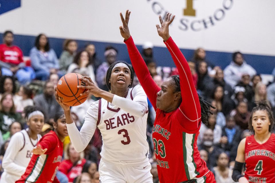 Lawrence Central High School sophomore Lola Lampley (3) shoots while being defended by Lawrence North High School junior Jamaya Thomas (33) during the first half of an IHSAA Class 4A Sectional semi-final basketball game, Friday, Feb. 2, 2024, at Cathedral High School.