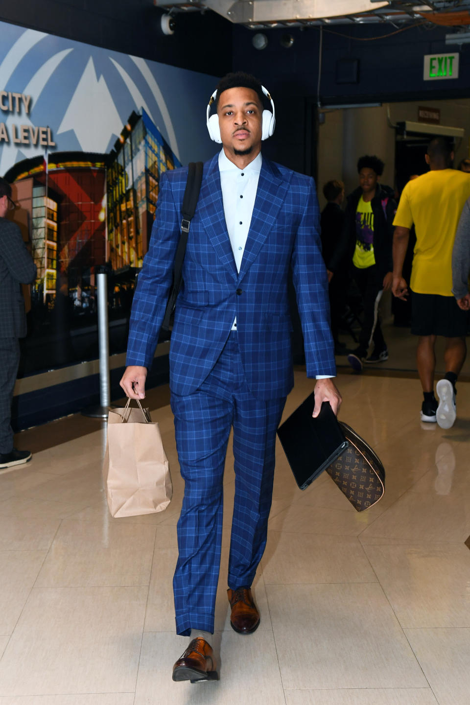 CJ McCollum of the Portland Trail Blazers wears dresses in a blue plaid suit on May 1, 2019.