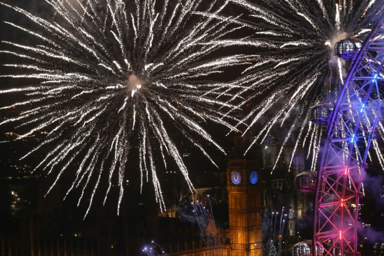 Fireworks explode around Big Ben during New Year's celebrations in London just after midnight on January 1, 2016