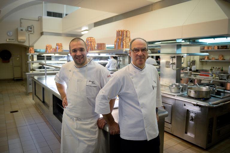 French Elysee presidential palace chef Bernard Vaussion (R) and his successor Guillaume Gomez (L) pose in the kitchen on October 31, 2013 at the Elysee palace in Paris