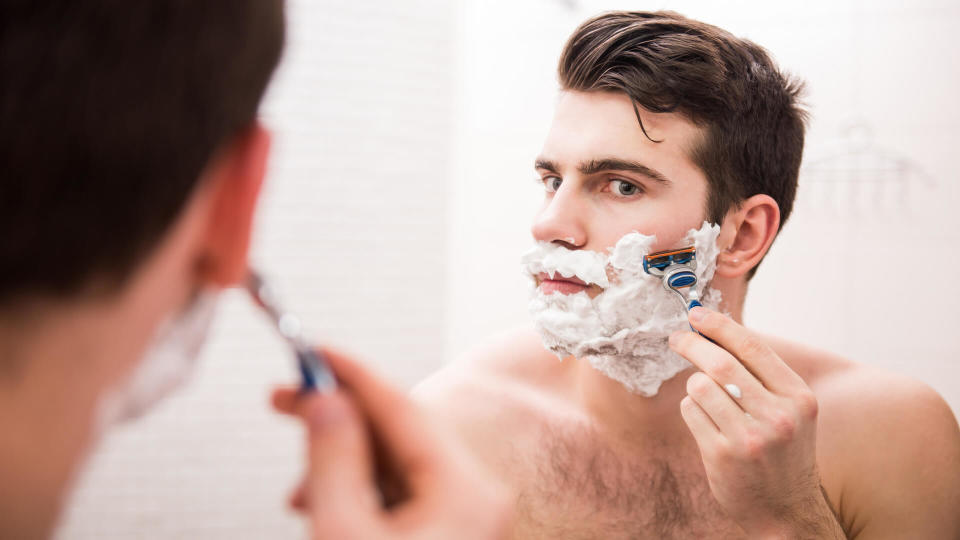 Man shaving face