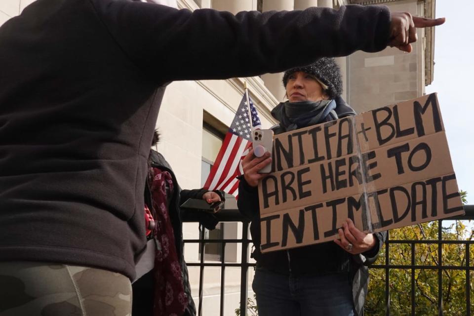 <div class="inline-image__caption"><p>Demonstrators argue outside the Kenosha County Courthouse during jury selection in the trial of Kyle Rittenhouse.</p></div> <div class="inline-image__credit">Scott Olson/Getty</div>