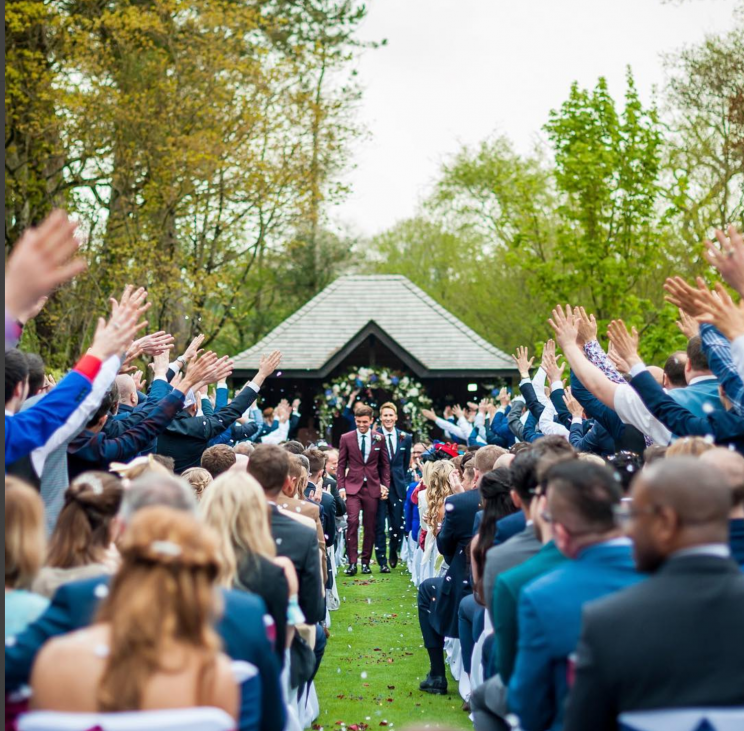 The grooms were joined by 150 guests.