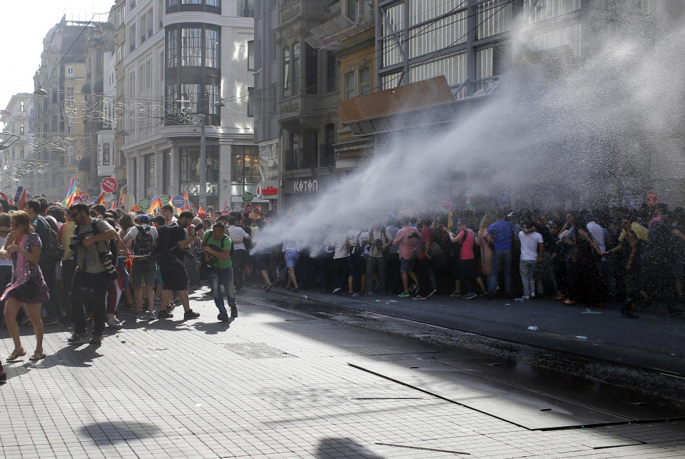 FILE - In this Sunday, June 28, 2015 file photo, Turkish police use a water cannon to disperse participants of a Pride Week march in Istanbul. For several years, Pride Week in Istanbul attracted tens of thousands of participants, making it one of largest gatherings celebrating gay, lesbian and transgender rights and diversity in the Muslim world. That changed suddenly in 2015, when authorities, citing security concerns, banned gay and trans-gender pride events chasing away shocked participants trying to converge on central Taksim Square with tear gas and water cannons. (AP Photo/Emrah Gurel, File)