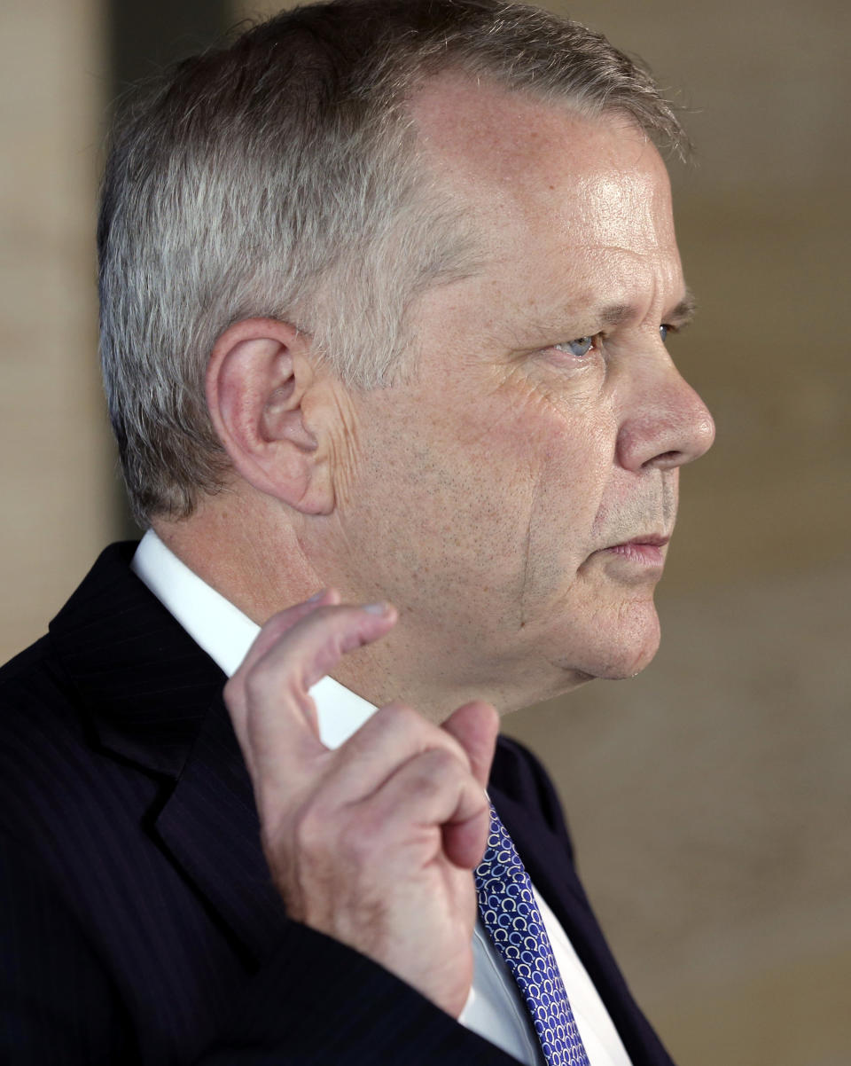 ANZ CEO Australia Philip Chronican holds up his hand while he answers questions during a press conference to discuss the outcome of the Federal Court ruling in the IMF fees class action in Sydney, Australia, Wednesday, Feb. 5, 2014. ANZ Banking Group Ltd. partially lost a class action law suit in the Australian Federal Court brought by more than 43,000 customers who claimed they had been charged excessive fees for years.(AP Photo/Rob Griffith)