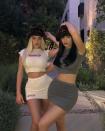 <p>With Stassie in a white crop top and mini skirt set along with an animal print fur bucket hat, Kylie wore the exact same — only her look was charcoal gray.</p>