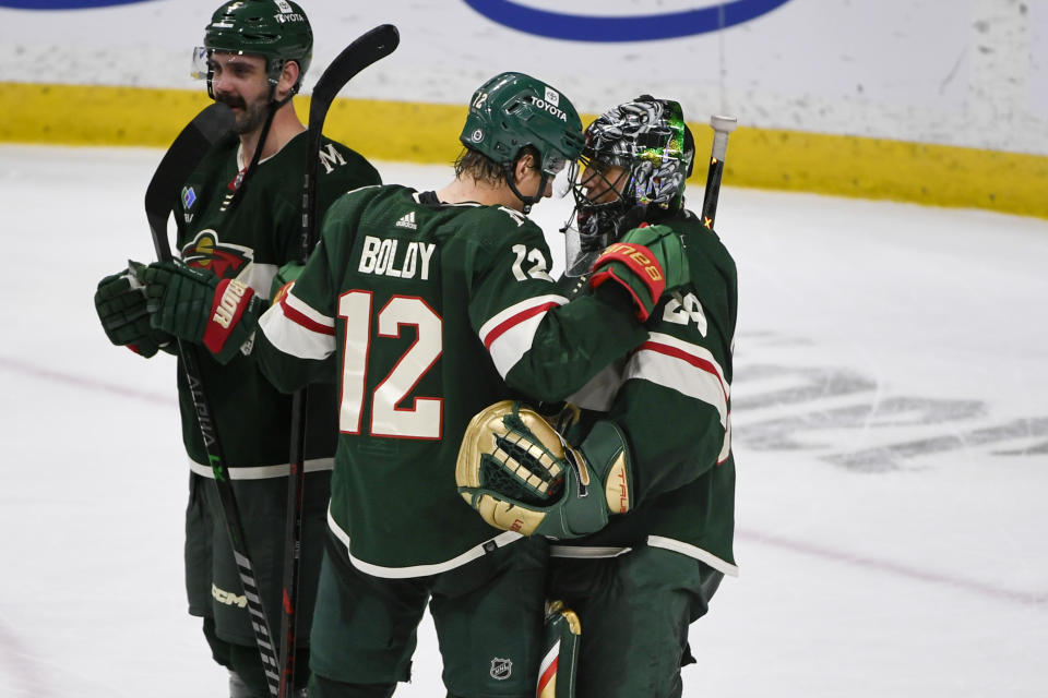 Minnesota Wild left wing Matt Boldy (12) celebrates with goalie Marc-Andre Fleury after defeating Seattle Kraken in an NHL hockey game Monday, March 27, 2023, in St. Paul, Minn. (AP Photo/Craig Lassig)