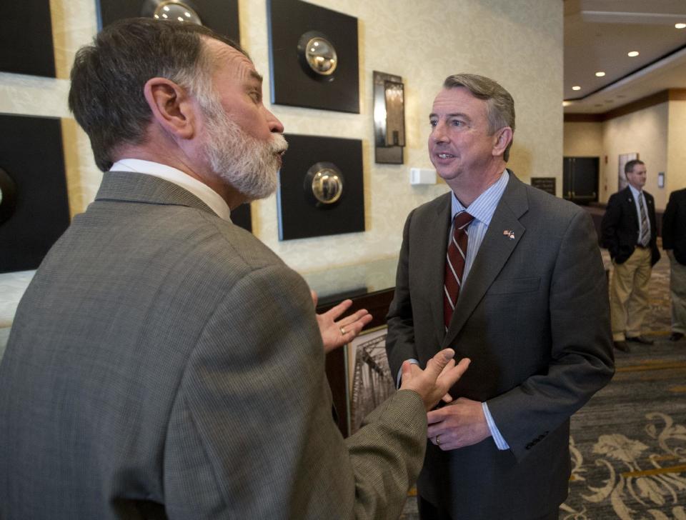 FILE - In this Friday, Jan. 27, 2017 file photo, Republican candidate for governor of Virginia, Ed Gillespie, right, talks with president of The Virginia Coal and Energy Alliance, Harry Childress, left, after a speech before a meeting of the Coal & Energy Alliance group in Richmond, Va. In what sounds like an echo of 2016, governor’s races this year in Virginia and New Jersey are being swept up in many of the same political currents that emerged during last year’s turbulent presidential campaign. (AP Photo/Steve Helber, File)