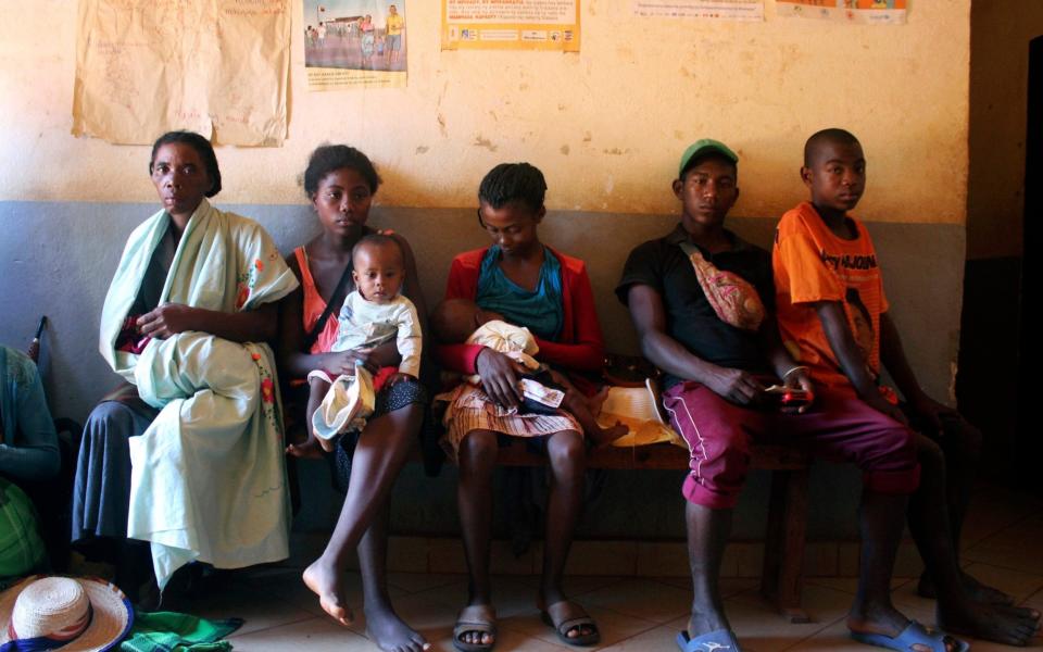 Mothers wait to have their babies vaccinated against measles, at a healthcare center in Larintsena, Madagascar - Laetitia Bezain/AP