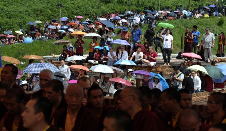 Buddhist monks and followers attend the funeral of senior Tibetan Buddhist monk Shamar Rinpoche at Shar Minub monastery in Kathmandu on July 31, 2014