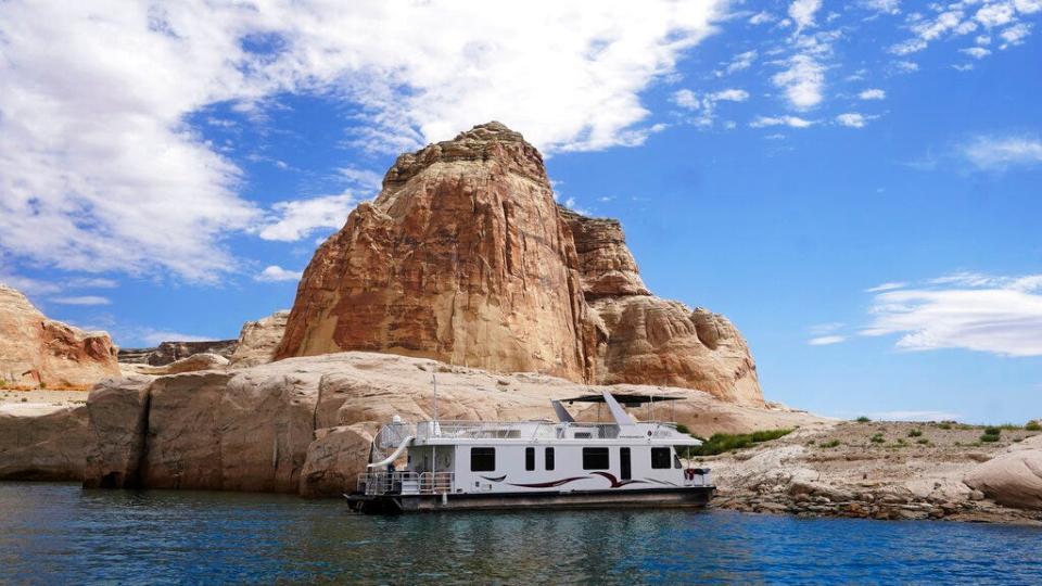 A houseboat rests in a cove at Lake Powell on July 30, 2021, near Page.