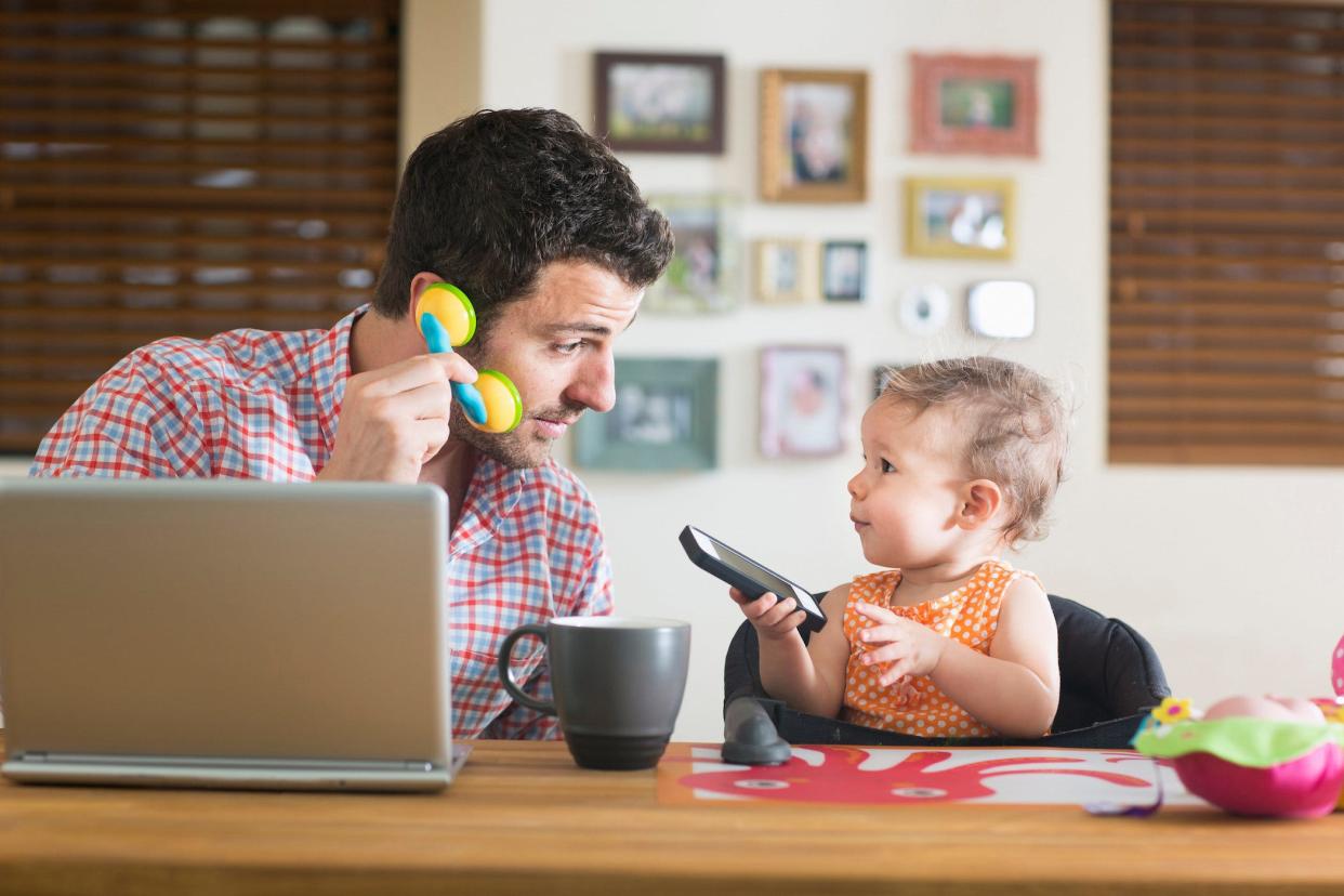 dad and baby on cellphones at home