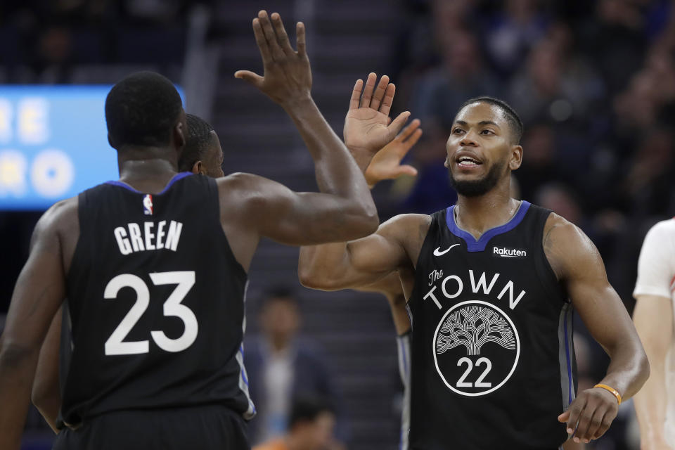 Golden State Warriors forward Glenn Robinson III (22) celebrates with forward Draymond Green (23) during the first half of the team's NBA basketball game against the Chicago Bulls in San Francisco, Wednesday, Nov. 27, 2019. (AP Photo/Jeff Chiu)