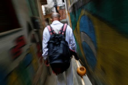 Manoel Pereira Costa, known as "Master Manel", walks in the Rocinha favela in Rio de Janeiro, Brazil, July 25, 2016. REUTERS/Bruno Kelly