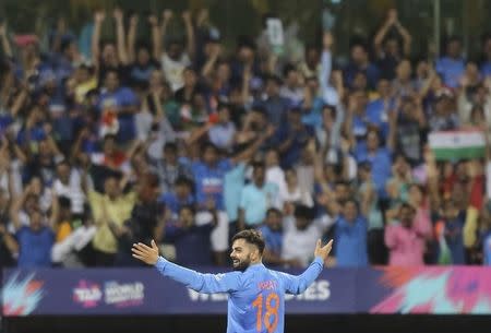 Cricket - West Indies v India - World Twenty20 cricket tournament semi-final - Mumbai, India - 31/03/2016. India's Virat Kohli celebrates taking the wicket of West Indies Johnson Charles. REUTERS/Shailesh Andrade