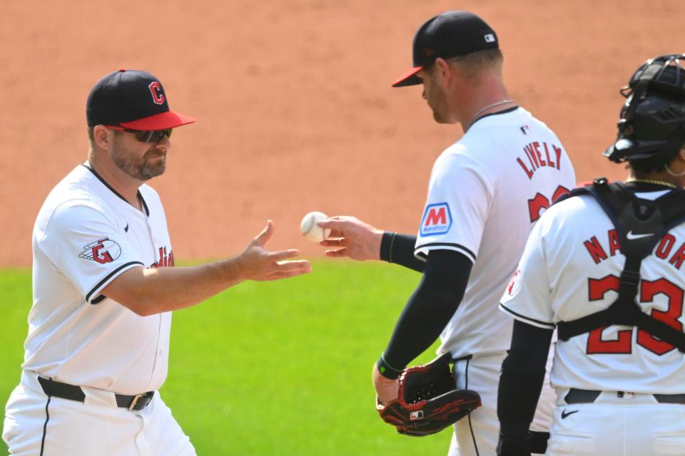 Cleveland Guardians manager Stephen Vogt (12) takes the ball from starting pitcher Ben Lively (39) during a pitching change against the Toronto Blue Jays on June 22  in Cleveland.