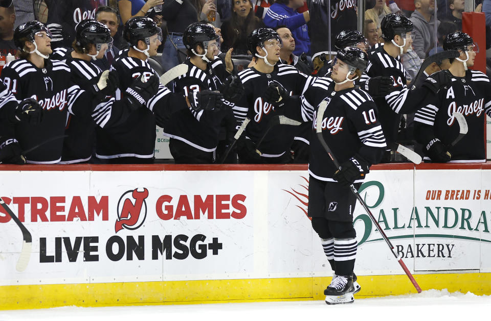 New Jersey Devils right wing Alexander Holtz (10) is congratulated for his goal against the Buffalo Sabres during the first period of an NHL hockey game Friday, Oct. 27, 2023, in Newark, N.J. (AP Photo/Noah K. Murray)