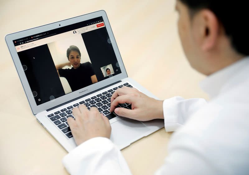 FILE PHOTO: Medical doctor Makoto Kitada demonstrates a telemedicine application service called 'CLINICS', in Tokyo