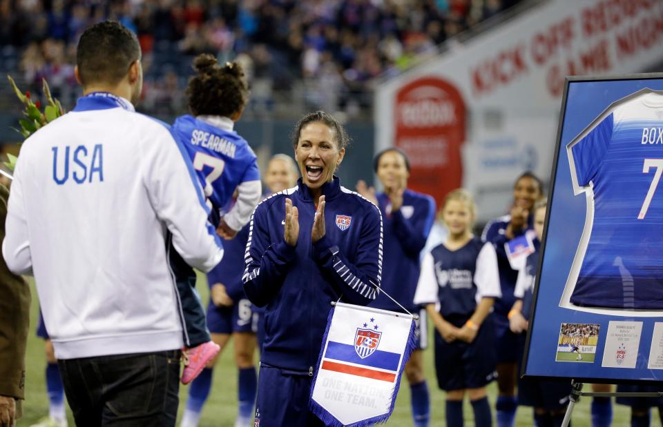 United States' Shannon Boxx, right, is greeted by her husband Aaron Spearman and their daughter Zoe Spearman, 20 months, before a friendly soccer match Wednesday, Oct. 21, 2015, in Seattle. The match was Boxx's last of her career. Boxx showed that representation matters while also redefining the role of a defensive midfielder for the U.S. women's national team. Boxx made 195 appearances with the national team, most in the history of the team for a Black woman. She was voted into the National Soccer Hall of Fame and was enshrined on Friday, May 21, 2022, in Frisco, Texas.