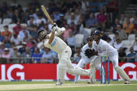 New Zealand's Kane Williamson, left, plays a shot during the first day of the third cricket test match between England and New Zealand at Headingley in Leeds, England, Thursday, June 23, 2022. (AP Photo/Rui Vieira)