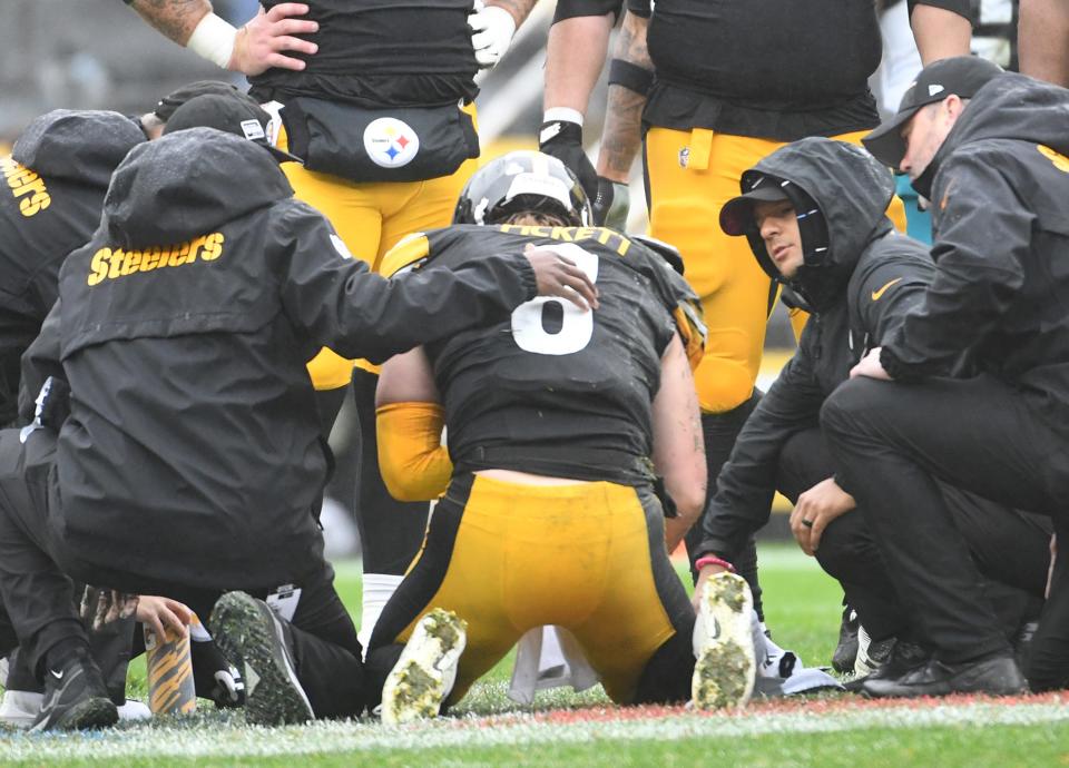 Pittsburgh Steelers quarterback Kenny Pickett (8) is tended to after taking a hit against the Jacksonville Jaguars during the second quarter at Acrisure Stadium.
