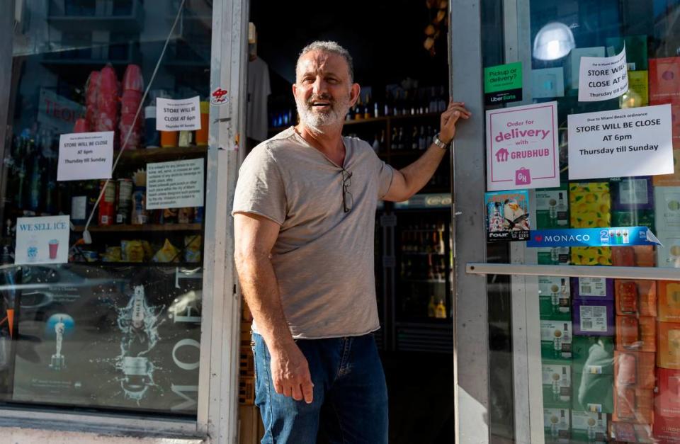 The storeowner of SOUTH BEACH LIQUOR stands outside of his store on Friday, March 24, 2023 in Miami Beach, Fla. After two deadly shootings, city officials voted not to re-impose a midnight curfew, but implemented an emergency order banning alcohol sales after 6 p.m.