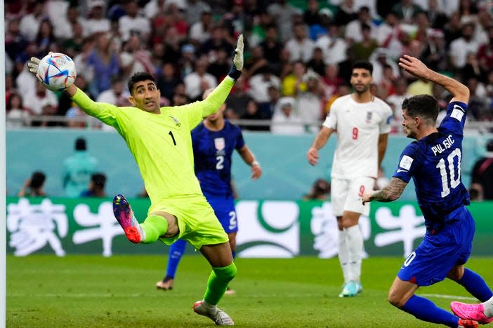 Christian Pulisic, right, of the United States, scored the only goal during Tuesday's World Cup Group B soccer match against Iran at Al Thumama Stadium in Doha, Qatar. The Iran goalkeeper is Alireza Beiranvand. The 1-0 win sent Team USA into the knockout round Saturday agaist the Netherlands.