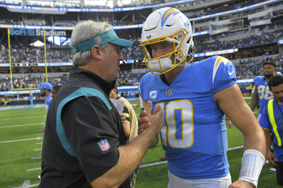 Jacksonville Jaguars head coach Doug Pederson, left, greets Los Angeles Chargers quarterback Justin Herbert (10) after an NFL football game in Inglewood, Calif., Sunday, Sept. 25, 2022. (AP Photo/Mark J. Terrill)