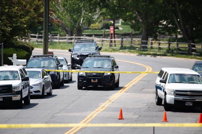 Layton Police cars wait outside the scene of a triple homicide in Layton on Friday, May 19, 2023. | Ryan Sun, Deseret News