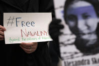 A woman holds a banner that reads: "Freedom of Navalny" during a rally in support of Russia's political prisoners in Belgrade, Serbia, Saturday, Jan. 21, 2023. A friendly, fellow-Slavic nation, Serbia has welcomed the fleeing Russians who need visas to travel to much richer Western European states. But in Serbia, they have not escaped the long reach of Putin's hardline regime influence.(AP Photo/Darko Vojinovic)