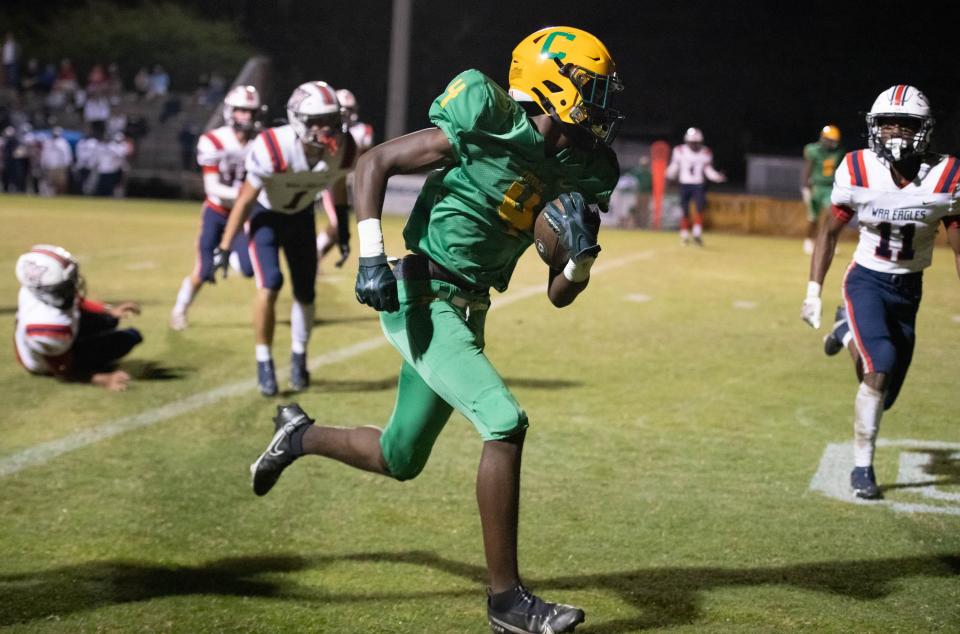 Jayvion Showers (4) takes it to the house for a touchdown and a 26-14 Crusaders lead during the Wakulla vs Catholic football game at Pensacola Catholic High School in Pensacola on Friday, Nov. 11, 2022.