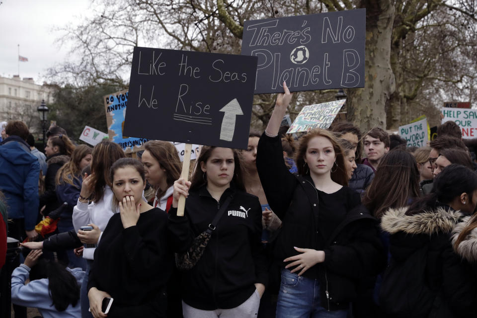 Youngsters take part in a student climate protest in London, Friday, March 15, 2019. Students in more than 80 countries and territories worldwide plan to skip class Friday in protest over their governments' failure to act against global warming. The coordinated 'school strike' was inspired by 16-year-old activist Greta Thunberg, who began holding solitary demonstrations outside the Swedish parliament last year. (AP Photo/Matt Dunham)
