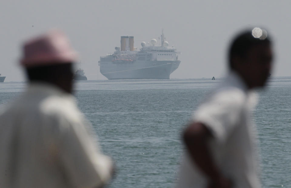 CORRECTS SPELLING OF HARBOR - The Costa Allegra is towed in Victoria harbor, Seychelles Island, Thursday, March 1, 2012. The disabled cruise ship arrived in port in the island nation of the Seychelles on Thursday morning after three days at sea without power. The Costa Allegra has been at sea with more than 1,000 people onboard and without electricity since a fire in the generator room on Monday. (AP Photo/Gregorio Borgia)