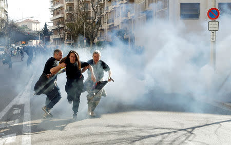 Protesters run away as tear gas is fired during 19th round of "yellow vests" protests in Nice, France, March 23, 2019. REUTERS/Eric Gaillard