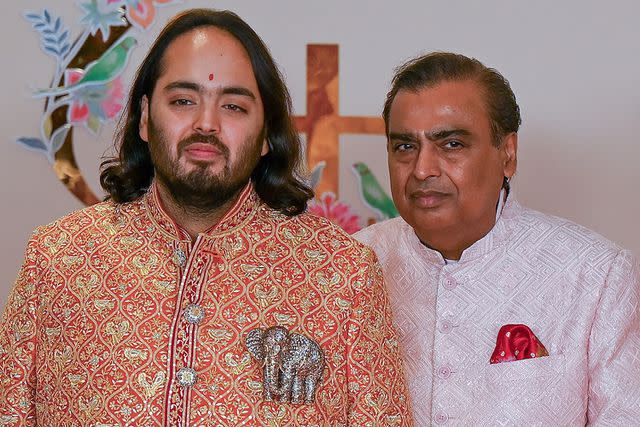 <p>PUNIT PARANJPEPUNIT PARANJPE/AFP via Getty</p> Billionaire tycoon and Chairman of Reliance Industries Mukesh Ambani poses for photos before the wedding ceremony of his son Anant Ambani (L) and Radhika Merchant in Mumbai on July 12, 2024