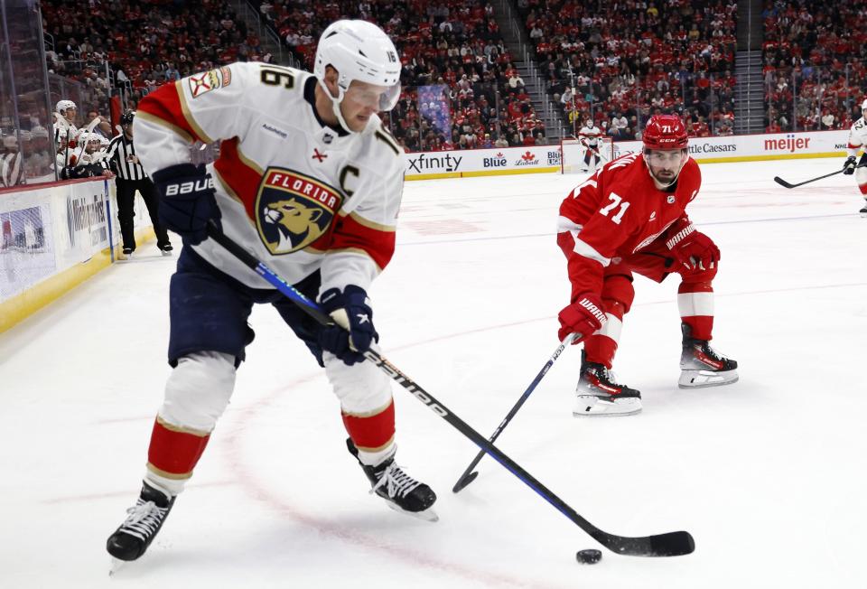 Florida Panthers center Aleksander Barkov (16) is guarded by Detroit Red Wings center Dylan Larkin (71) during the second period of an NHL hockey game Saturday, March 2, 2024, in Detroit. (AP Photo/Duane Burleson)