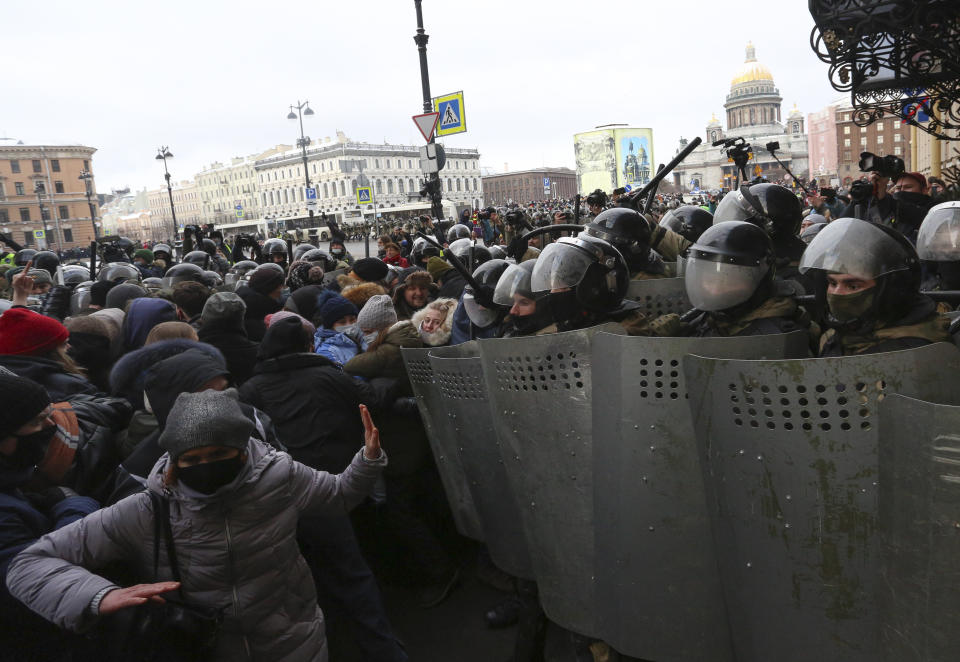 Police stand blocking approaches to the street as protesters try to break through during a protest against the jailing of opposition leader Alexei Navalny in St. Petersburg, Russia, Sunday, Jan. 31, 2021. Thousands of people have taken to the streets across Russia to demand the release of jailed opposition leader Alexei Navalny, keeping up the wave of nationwide protests that have rattled the Kremlin. Hundreds have been detained by police. (AP Photo/Valentin Egorshin)