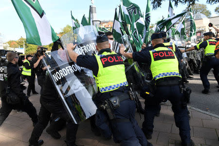 Police officers stop NMR demonstrators from trying to walk along a forbidden street during the Nordic Resistance Movement (NMR) march in central Gothenburg, Sweden September 30, 2017. Fredrik Sandberg/TT News Agency/via REUTERS