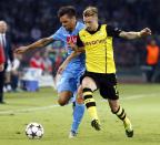 Napoli's Christian Maggio (L) and Borussia Dortmund's Marco Reus fight for the ball during their Champions League Group F soccer match at San Paolo stadium in Naples September 18, 2013. REUTERS/Stefano Rellandini (ITALY - Tags: SPORT SOCCER)