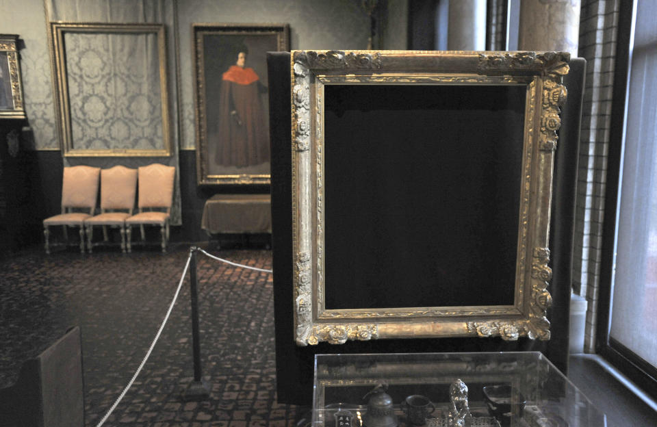 FILE - In this Thursday, March 11, 2010 file photo, empty frames from which thieves took "Storm on the Sea of Galilee," left background, by Rembrandt and "The Concert," right foreground, by Vermeer, remain on display at the Isabella Stewart Gardner Museum in Boston. The paintings are among 13 works stolen by burglars from the museum in the early hours of March 18, 1990. The FBI said Monday, March 18, 2013, it believes it knows the identities of the thieves who stole the art. Richard DesLauriers, the FBI's special agent in charge in Boston, says the thieves belong to a criminal organization based in New England the mid-Atlantic states.  (AP Photo/Josh Reynolds, File)