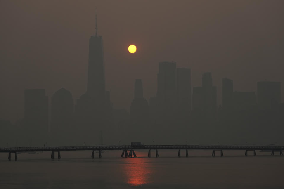 The sun rises over the lower Manhattan skyline as seen from Jersey City, N.J., Thursday, June 8, 2023. Intense Canadian wildfires are blanketing the northeastern U.S. in a dystopian haze, turning the air acrid, the sky yellowish gray and prompting warnings for vulnerable populations to stay inside. (AP Photo/Seth Wenig)