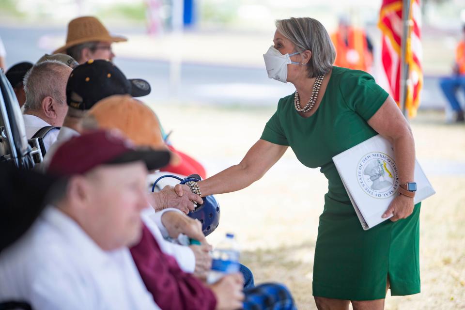 New Mexico Gov. Michelle Lujan Grisham shakes hands with veterans during a groundbreaking event for a veterans' home in Truth or Consequences on Tuesday, July 26, 2022.